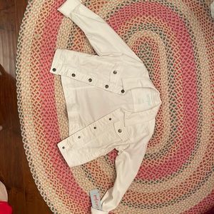 The white jean jacket that has never been worn and still has the tag on it.